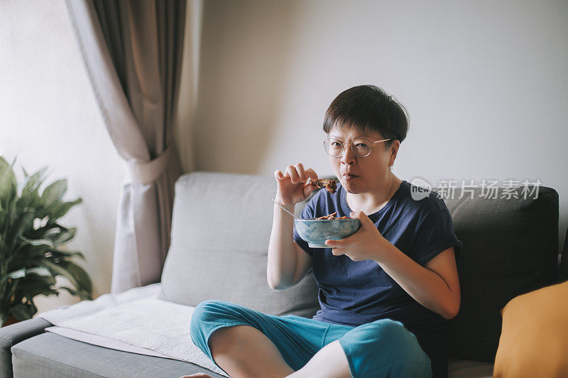 an asian chinese mid adult woman order a take out food from delivery and prepare to have her lunch at home